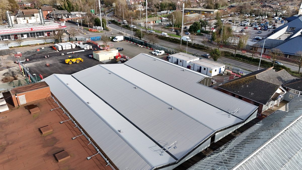 Aerial drone view of a large market canopy roof fitted alongside existing retail units