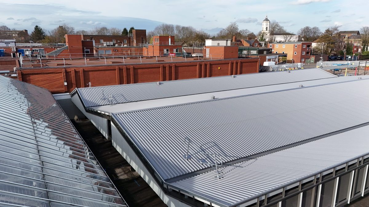 Steel canopy roof with glazed panels partially fitted between the purlins